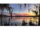 Scenic lake view at sunset with beautiful, colorful reflections on the water and Spanish moss at 320 Mary Jess Rd, Orlando, FL 32839