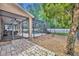 Spacious fenced backyard featuring a brick patio, screen enclosure, and lush green grass at 353 Meadow Beauty Ter, Sanford, FL 32771