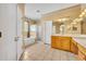 Spacious bathroom with dual vanity, tile floors, soaking tub and glass-enclosed shower at 353 Meadow Beauty Ter, Sanford, FL 32771