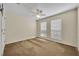 Cozy bedroom with neutral carpet, ceiling fan, and two windows offering natural light and views at 353 Meadow Beauty Ter, Sanford, FL 32771