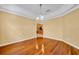 Formal dining room with wood flooring, decorative lighting, and an arched entrance to the kitchen at 353 Meadow Beauty Ter, Sanford, FL 32771