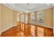 Formal dining room with gleaming hardwood floors, crown molding, and decorative light fixture at 353 Meadow Beauty Ter, Sanford, FL 32771