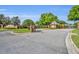 Benington Club entrance with well manicured landscaping and guard house at 353 Meadow Beauty Ter, Sanford, FL 32771