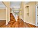 Bright entryway with polished hardwood floors and a staircase leading to the upper level at 353 Meadow Beauty Ter, Sanford, FL 32771