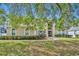Home featuring a well-manicured lawn, lush landscaping, and a welcoming front entrance at 353 Meadow Beauty Ter, Sanford, FL 32771