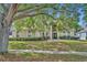 Charming home featuring a well-manicured lawn, lush landscaping, and a welcoming front entrance at 353 Meadow Beauty Ter, Sanford, FL 32771