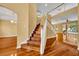 Inviting foyer showcasing hardwood floors, stairs, and open access to the living spaces at 353 Meadow Beauty Ter, Sanford, FL 32771