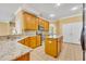 Well-equipped kitchen features granite countertops, an island, and ample cabinet space at 353 Meadow Beauty Ter, Sanford, FL 32771