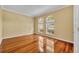 Living room with hardwood floors, bright arched windows with views of front yard and neighborhood at 353 Meadow Beauty Ter, Sanford, FL 32771