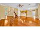 Open-concept living area with hardwood floors and staircase, seamlessly connecting to the kitchen at 353 Meadow Beauty Ter, Sanford, FL 32771