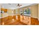 Spacious living room with hardwood floors, ceiling fan and sliding door to the lanai at 353 Meadow Beauty Ter, Sanford, FL 32771