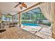 Inviting screened-in pool with brick patio and covered seating area perfect for relaxation at 353 Meadow Beauty Ter, Sanford, FL 32771