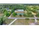 Aerial view of the house featuring a serene pond and verdant surroundings at 3550 Kaiser Ave, St Cloud, FL 34772
