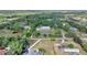 Stunning aerial view showcasing the house, pond, and surrounding lush greenery at 3550 Kaiser Ave, St Cloud, FL 34772