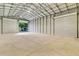 Spacious metal barn interior featuring roll-up doors and a sturdy concrete floor at 3550 Kaiser Ave, St Cloud, FL 34772