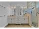 Bathroom featuring dual vanity, updated hardware, walk-in glass shower, and stone accents at 3550 Kaiser Ave, St Cloud, FL 34772