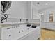 Bright bathroom featuring a large jacuzzi tub, and white cabinets with a modern design at 3550 Kaiser Ave, St Cloud, FL 34772