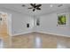 Large, light-filled bedroom with a ceiling fan, multiple windows, and neutral decor at 3550 Kaiser Ave, St Cloud, FL 34772