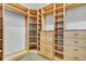 Custom walk-in closet with wooden shelves, drawers and granite countertop at 3550 Kaiser Ave, St Cloud, FL 34772