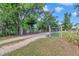 Gravel driveway leading to gated property, enhancing privacy and a sense of arrival at 3550 Kaiser Ave, St Cloud, FL 34772