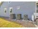 Side view of the home showing the outdoor equipment including three AC units at 3550 Kaiser Ave, St Cloud, FL 34772