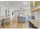 Open kitchen featuring blue cabinets, farmhouse sink, marble countertops and stainless steel appliances at 3550 Kaiser Ave, St Cloud, FL 34772