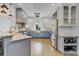 Bright kitchen with white and blue cabinets, stainless steel appliances, and marble countertops at 3550 Kaiser Ave, St Cloud, FL 34772