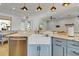 Bright kitchen with white farmhouse sink, blue cabinets, and marble countertops at 3550 Kaiser Ave, St Cloud, FL 34772