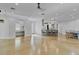 Expansive open-concept area featuring concrete floors, modern lighting, and a kitchen with a breakfast bar at 3550 Kaiser Ave, St Cloud, FL 34772