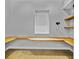 Office space with natural wood desk and shelving, and neutral walls at 3550 Kaiser Ave, St Cloud, FL 34772