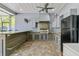 Outdoor kitchen with a built-in BBQ, a bar with light gray colored cabinets and brick floor at 3550 Kaiser Ave, St Cloud, FL 34772