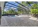 Inviting screened-in pool and spa with brick pavers and an outdoor dining area at 3550 Kaiser Ave, St Cloud, FL 34772