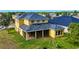 A spacious backyard featuring a screen-enclosed lanai with ample privacy and green space at 369 James Cir, Lake Alfred, FL 33850