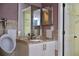 This bathroom features a white vanity with granite counters, dual mirrors, and a toilet at 369 James Cir, Lake Alfred, FL 33850