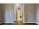 Bedroom with ensuite bathroom featuring double doors and laminate flooring at 369 James Cir, Lake Alfred, FL 33850