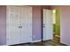 Bedroom with a lavender wall, wood-look floors, and a closet and entry door at 369 James Cir, Lake Alfred, FL 33850