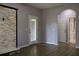 Bedroom with entry to front door, view of two doorways and modern stone fireplace at 369 James Cir, Lake Alfred, FL 33850