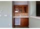 Butler's pantry showcasing glass cabinets, tile backsplash, white countertops, and updated fixtures at 369 James Cir, Lake Alfred, FL 33850