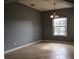 Empty dining room featuring tile floors, modern lighting, and large windows with natural light at 369 James Cir, Lake Alfred, FL 33850