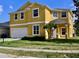 Charming two-story home featuring a well-maintained lawn, bright exterior paint and an attached two car garage at 369 James Cir, Lake Alfred, FL 33850