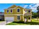 Charming two-story home featuring a well-maintained lawn, bright exterior paint and an attached two car garage at 369 James Cir, Lake Alfred, FL 33850