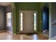 Bright foyer featuring tile floors, arched doorways, and neutral paint colors with large windows at 369 James Cir, Lake Alfred, FL 33850