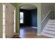 Bright foyer featuring tile floors, arched doorways, neutral paint colors and staircase at 369 James Cir, Lake Alfred, FL 33850