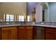 Bright kitchen featuring granite counters, wood cabinets, stainless dishwasher, and adjacent living area at 369 James Cir, Lake Alfred, FL 33850