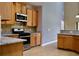 Well-equipped kitchen with granite countertops, modern appliances, and wooden cabinetry at 369 James Cir, Lake Alfred, FL 33850