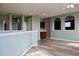 Open living space showcasing light walls, wood-look floors, with a butler's pantry and pass-through to other rooms at 369 James Cir, Lake Alfred, FL 33850