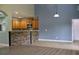 Spacious living area with stone countertop bar, wood floors, and wood cabinets at 369 James Cir, Lake Alfred, FL 33850