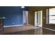 Open living room with tile and laminate floors, slider doors to the back and views of the kitchen at 369 James Cir, Lake Alfred, FL 33850