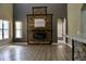 Bright living room with stone fireplace and wood flooring with entry to kitchen at 369 James Cir, Lake Alfred, FL 33850