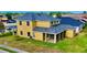 Two-story home showing a spacious backyard and screened lanai area at 369 James Cir, Lake Alfred, FL 33850